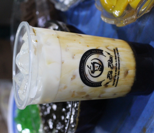 Fresh Milk with Brown Sugar Pearls in a Bà Bầu branded cup